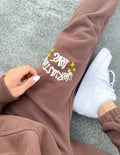 Unisex brown sweatpants with Love star logo on side, tapered ankle cuff