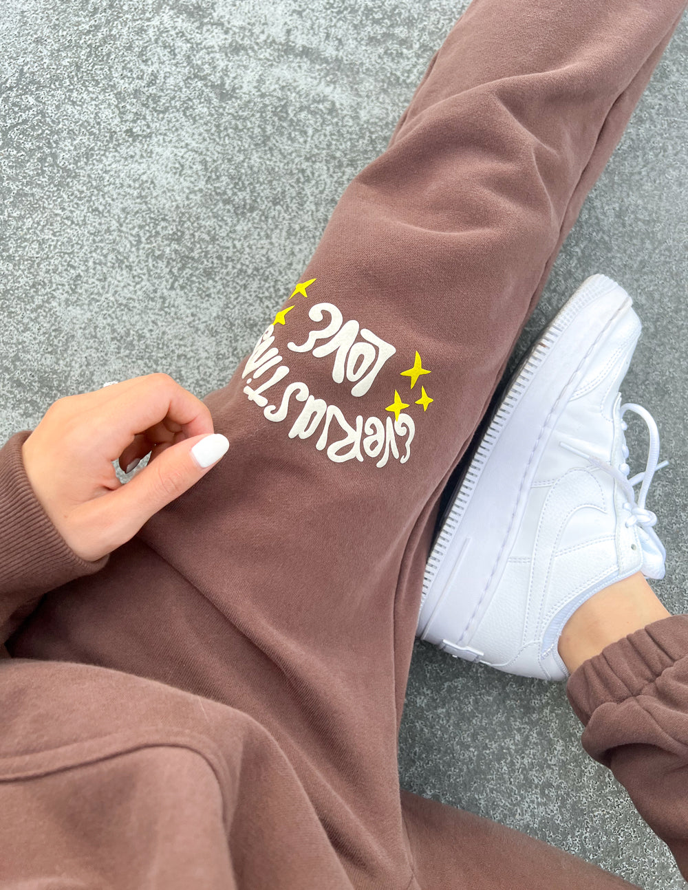 Unisex brown sweatpants with Love star logo on side, tapered ankle cuff