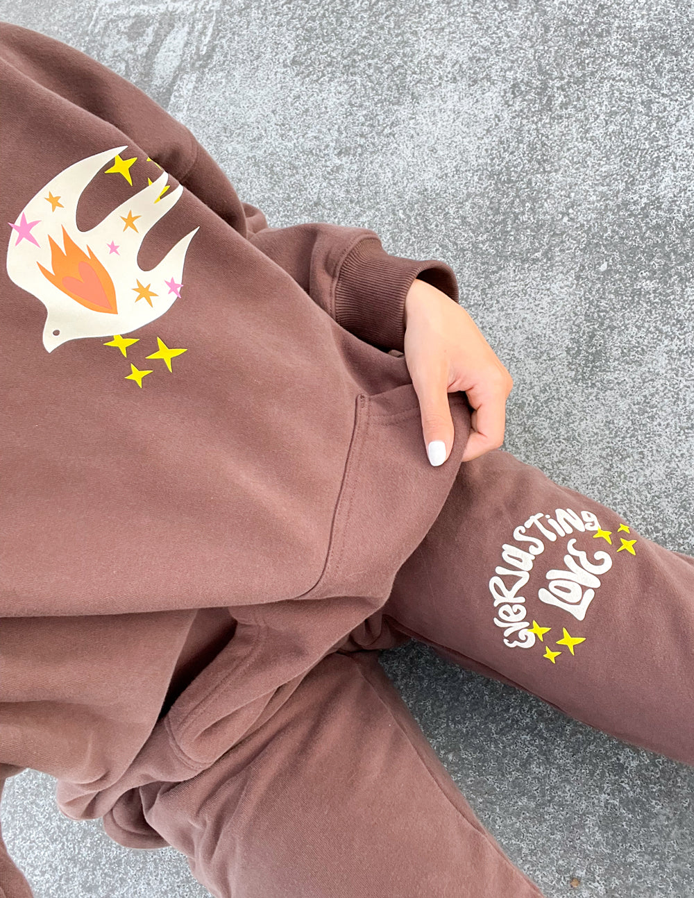 Unisex brown sweatpants with colorful side cuff graphic, relaxed fit
