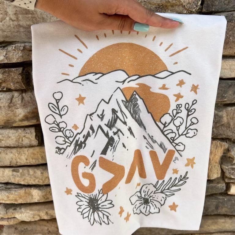 White Christian T-shirt with illustrated mountains, sun, and 'GOD SAVE' text