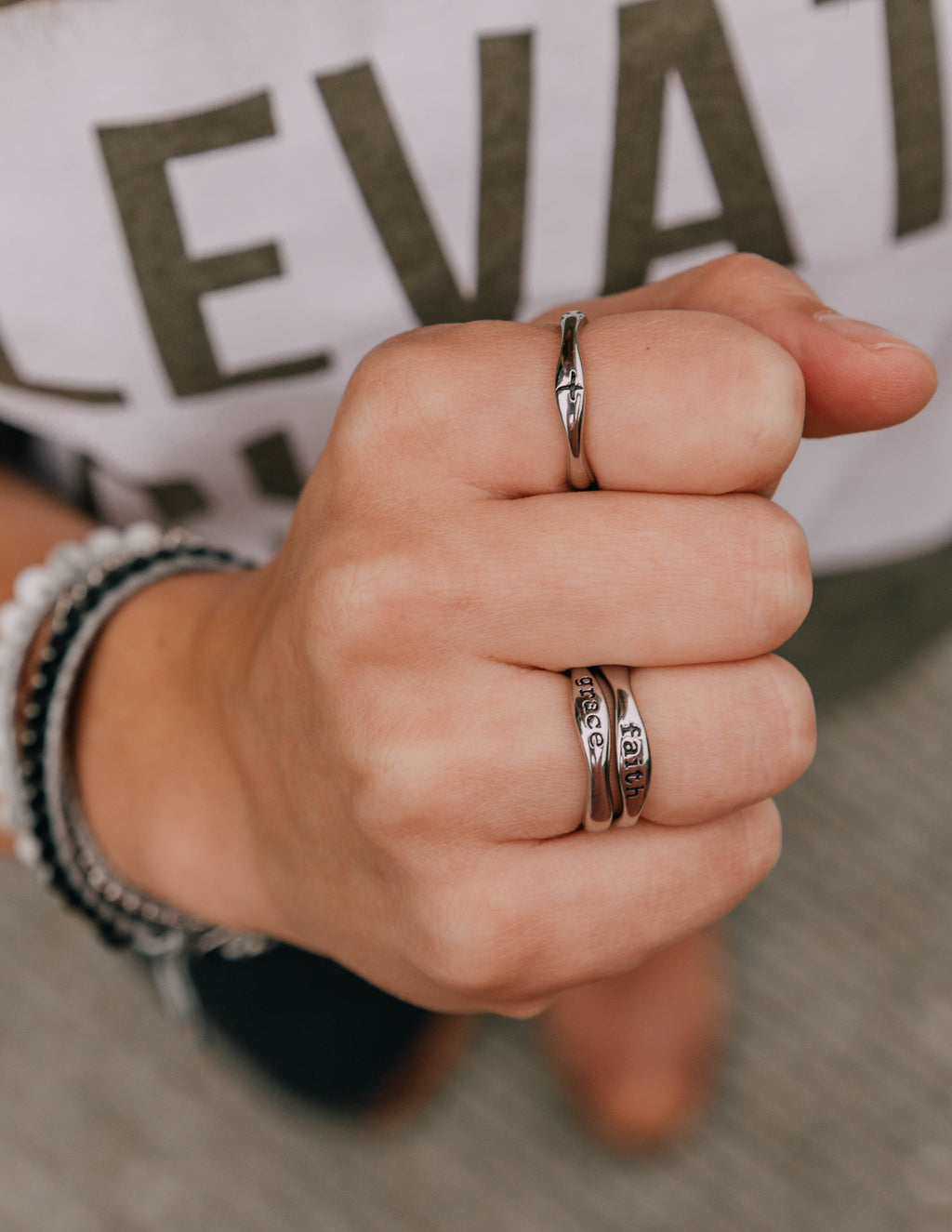 Set of silver stack rings with engraved bands and small hoop accents