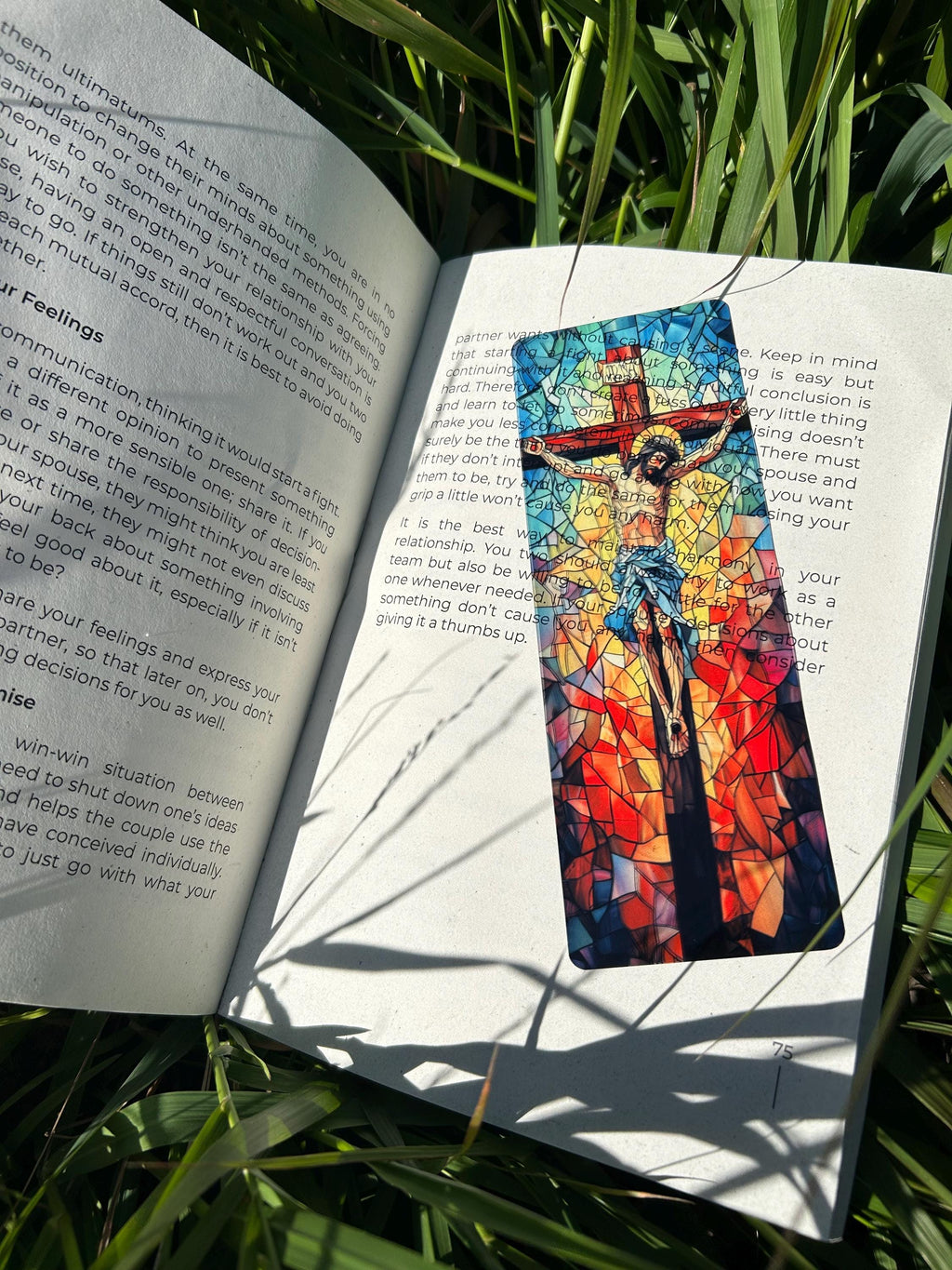 Handmade Christian bookmark with mosaic-style Jesus on the cross, in an open book