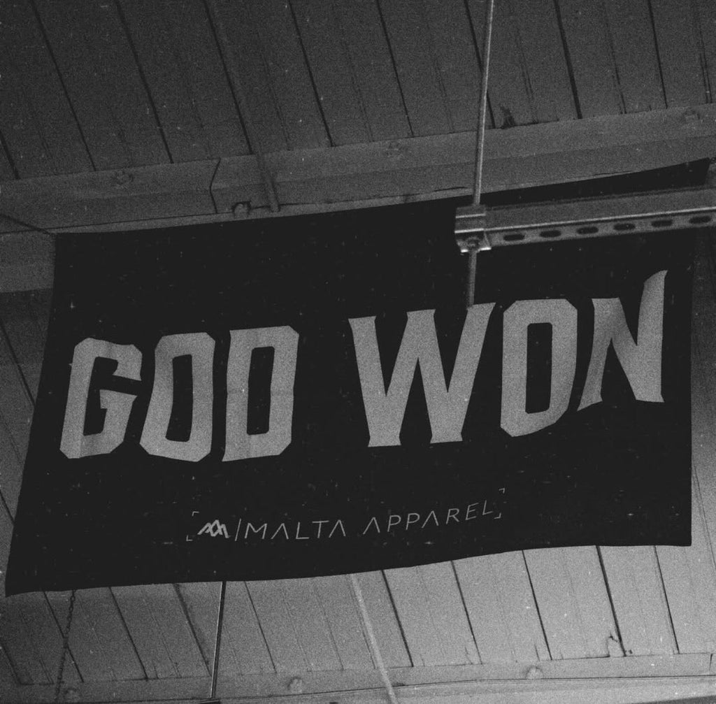 God Won flag, black with angled white 'GOD WON' lettering and MALTA APPAREL