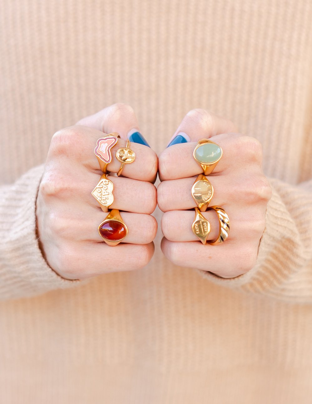 Gold-tone heart rings with red and green enamel 'God is love' text