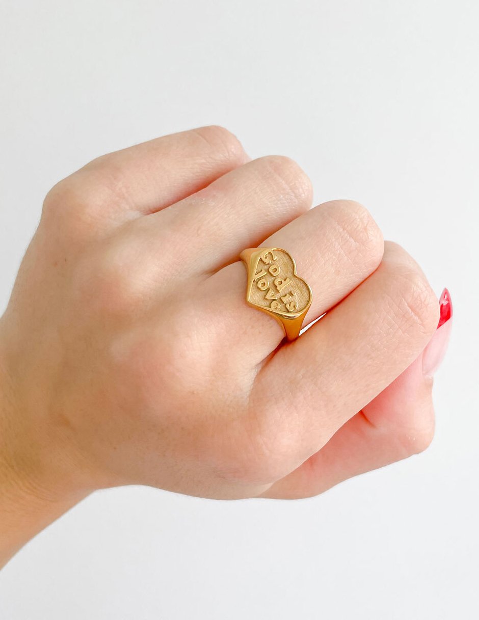 Gold-tone heart signet ring with 'God is love' engraving