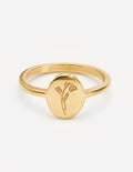 Gold wildflower signet ring with thin band and small floral engraving on round face