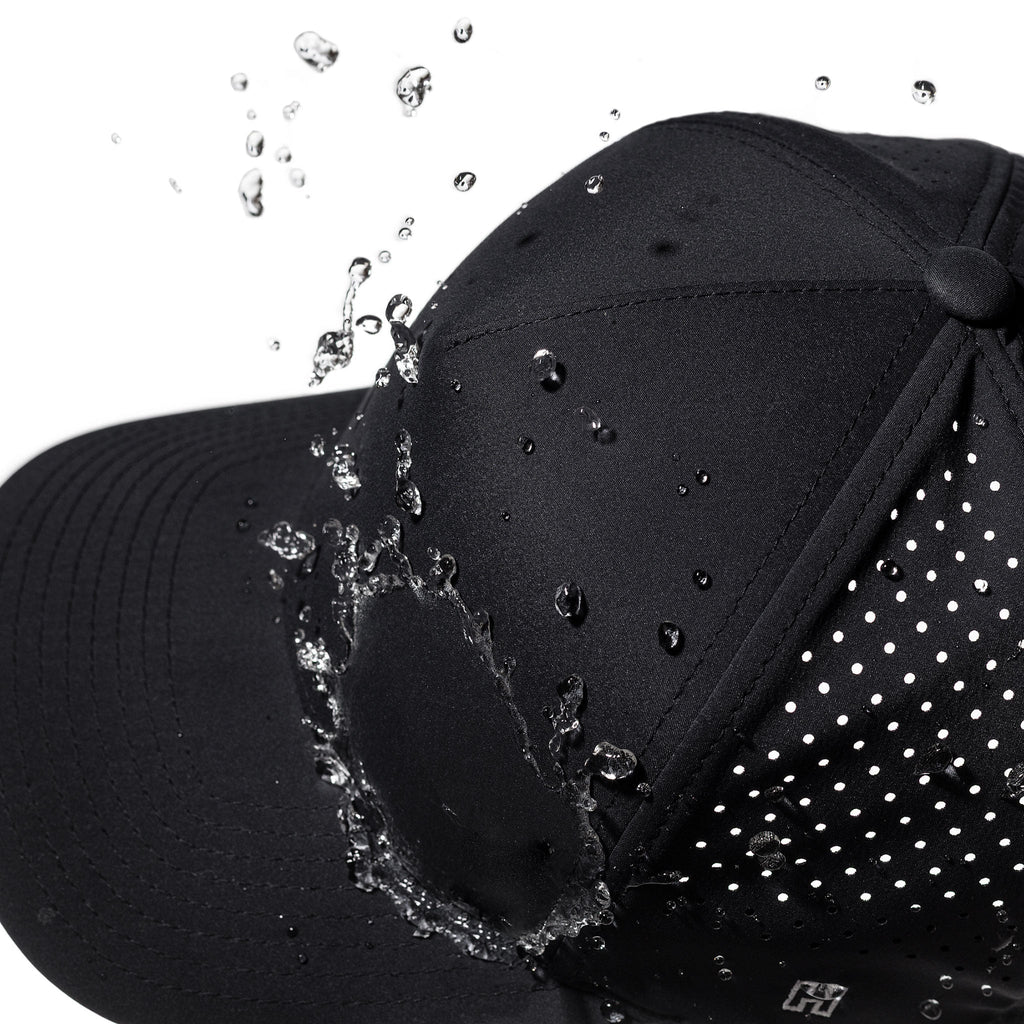 Black 5-panel hat close-up with water droplets and H logo