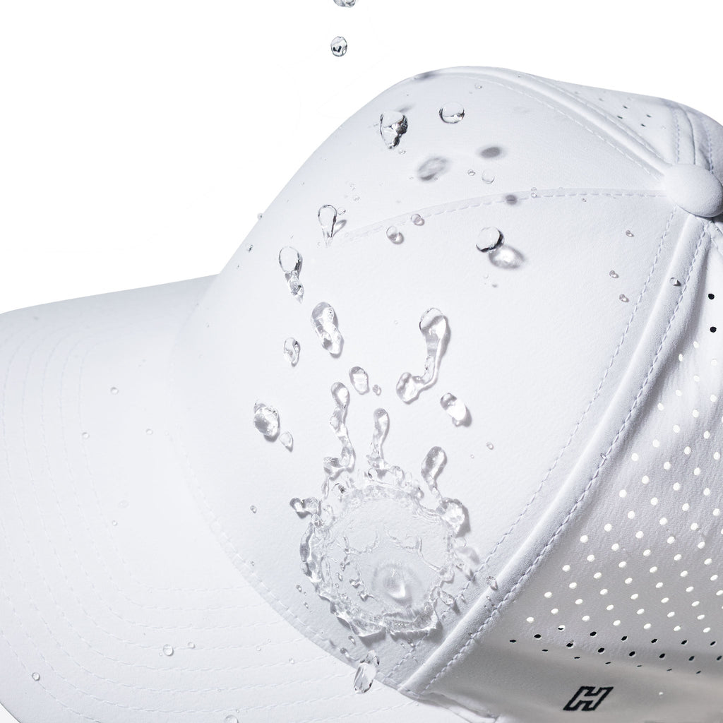 White 5-panel hat close-up with water droplets and perforated side