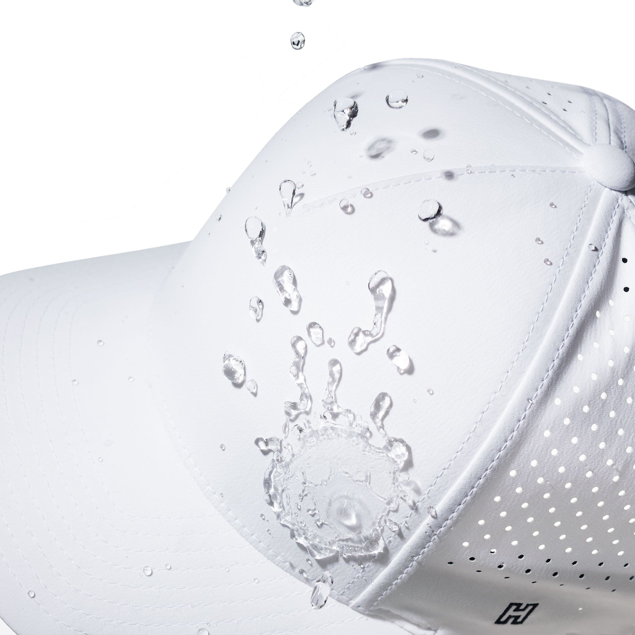 White 5-panel hat close-up with water droplets and perforated side