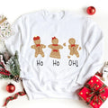 White crewneck sweatshirt with gingerbread trio graphic and Ho Ho Oh! lettering