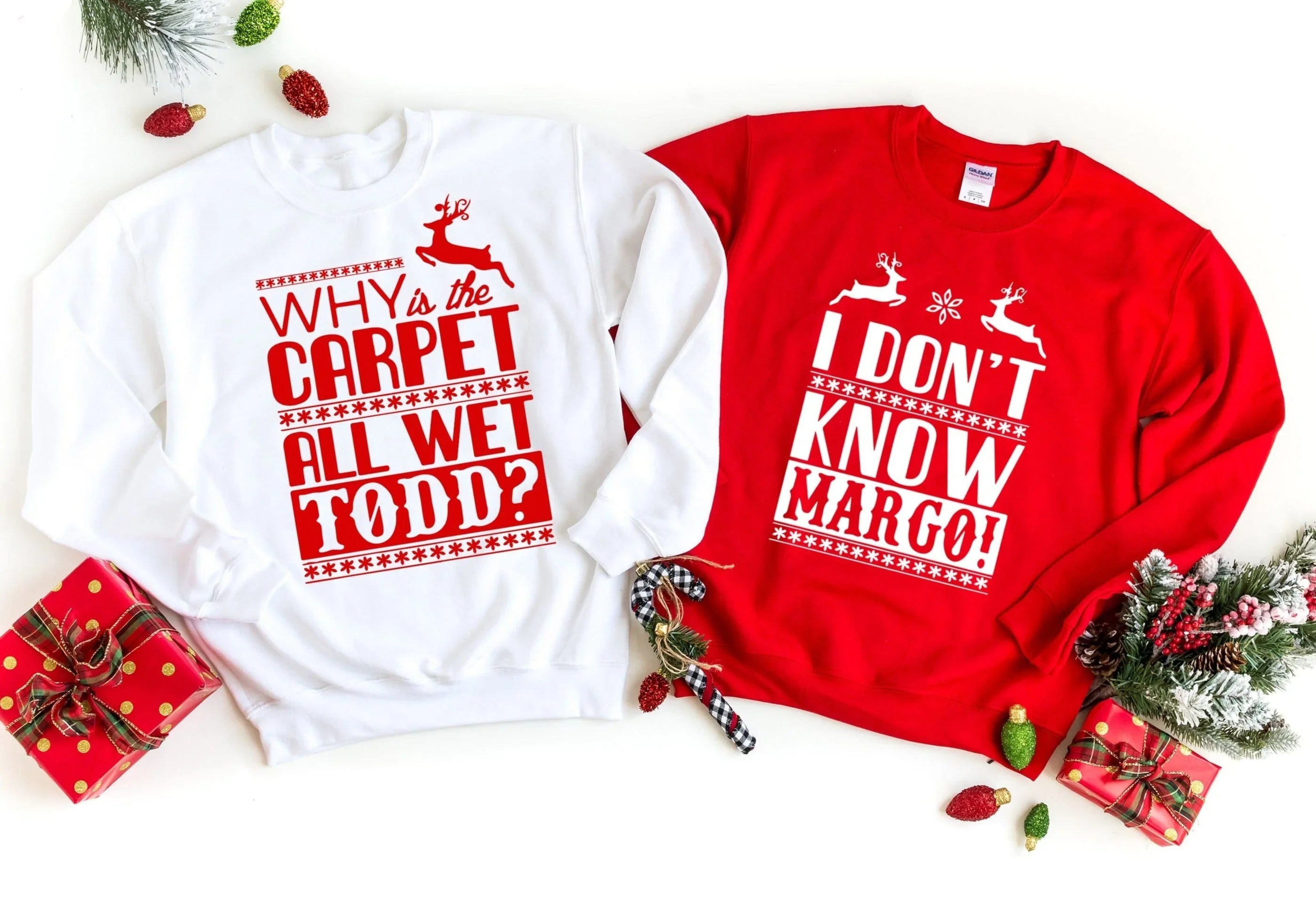 Red and white sweatshirts with holiday text and reindeer graphics, crewneck long sleeves