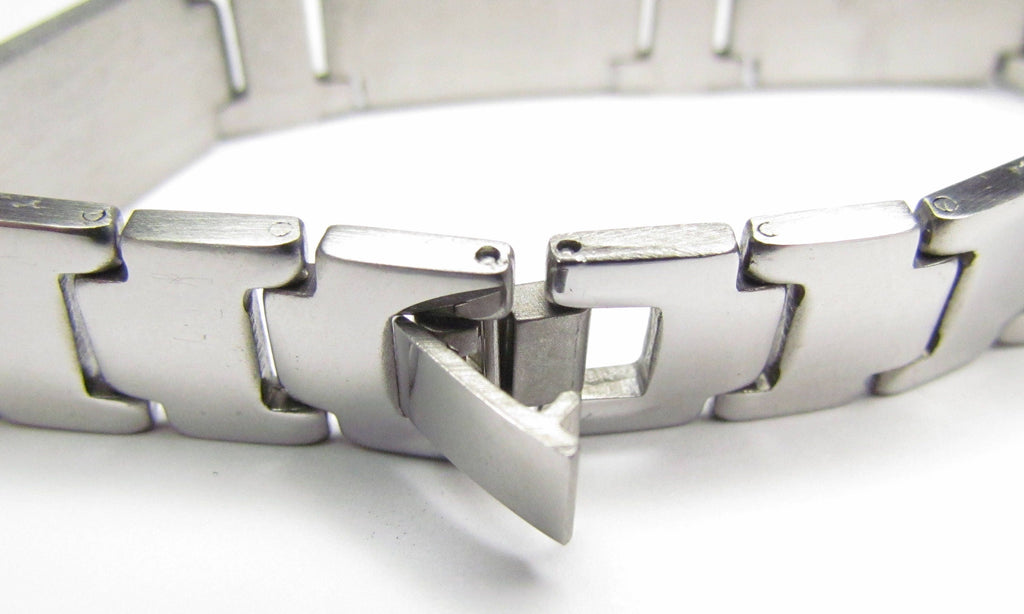 Stainless steel cross bracelet inner view with stacked clasp and engraved link center