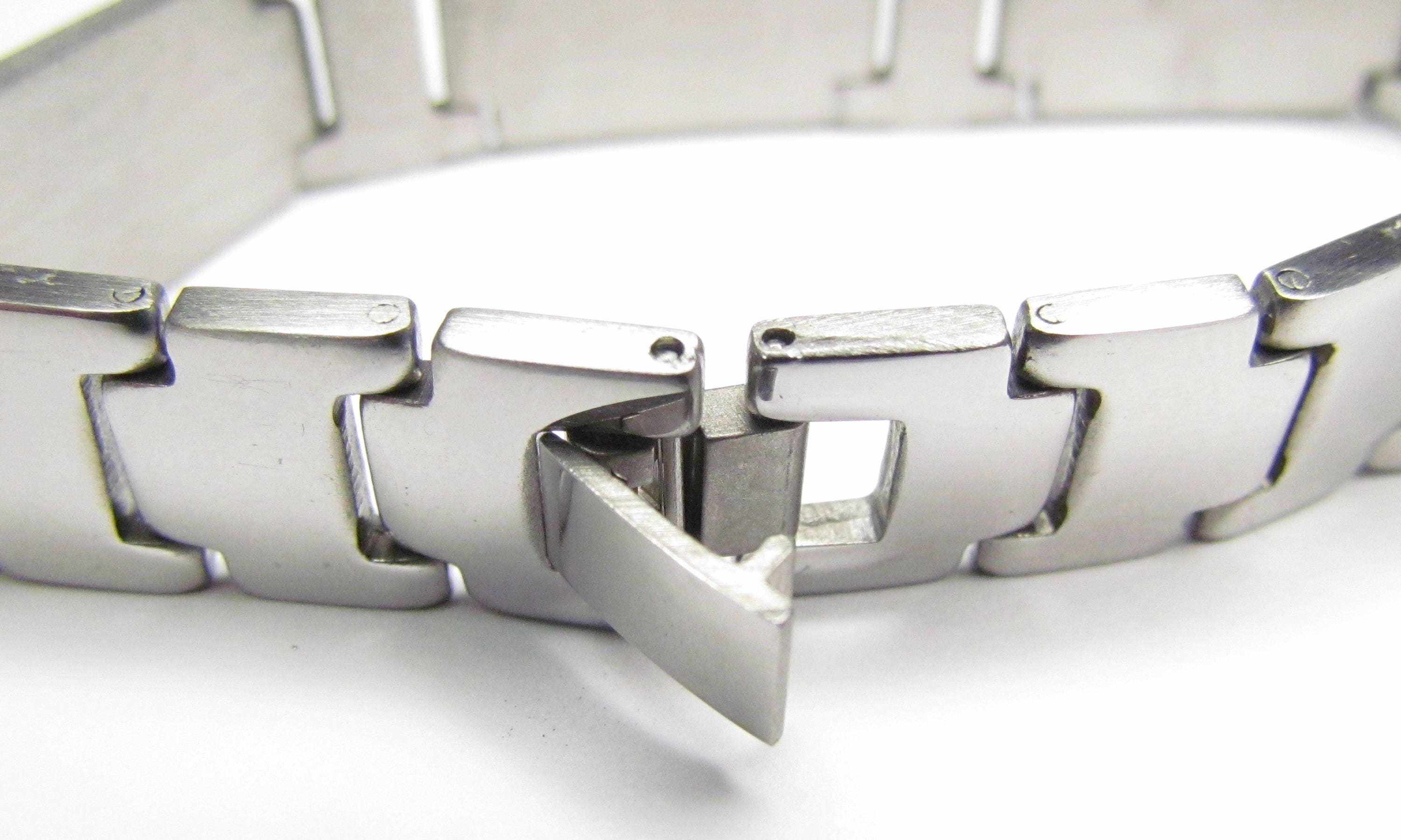 Stainless steel cross bracelet inner view with stacked clasp and engraved link center