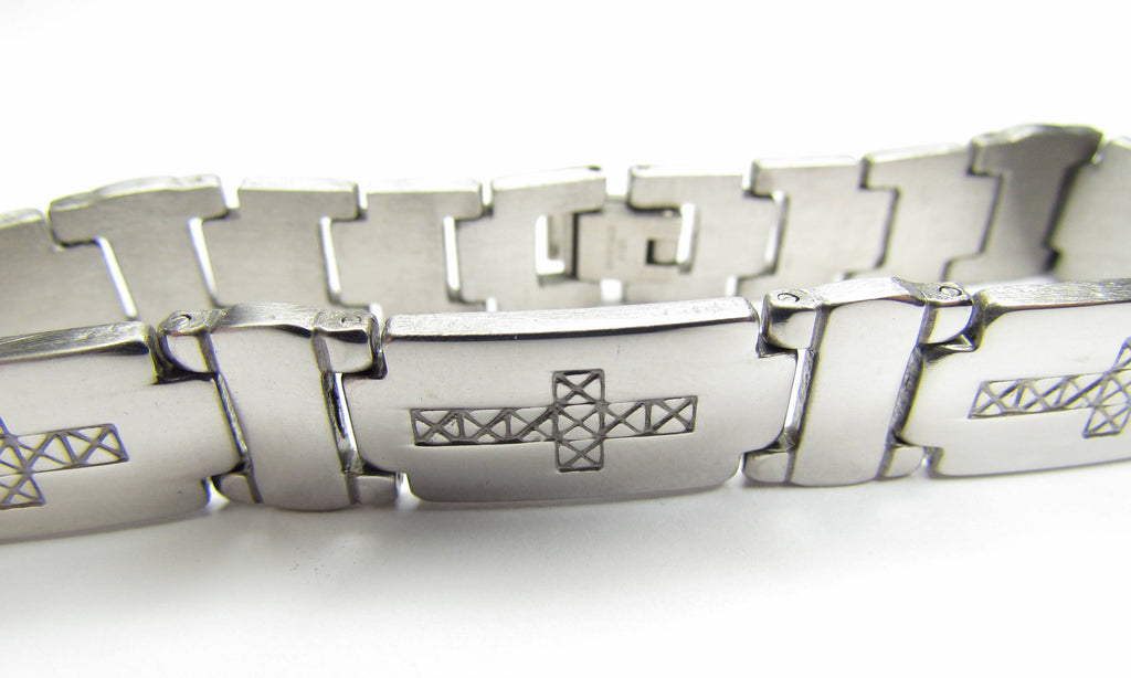 Stainless steel cross bracelet angled view with engraved horizontal cross and link edges