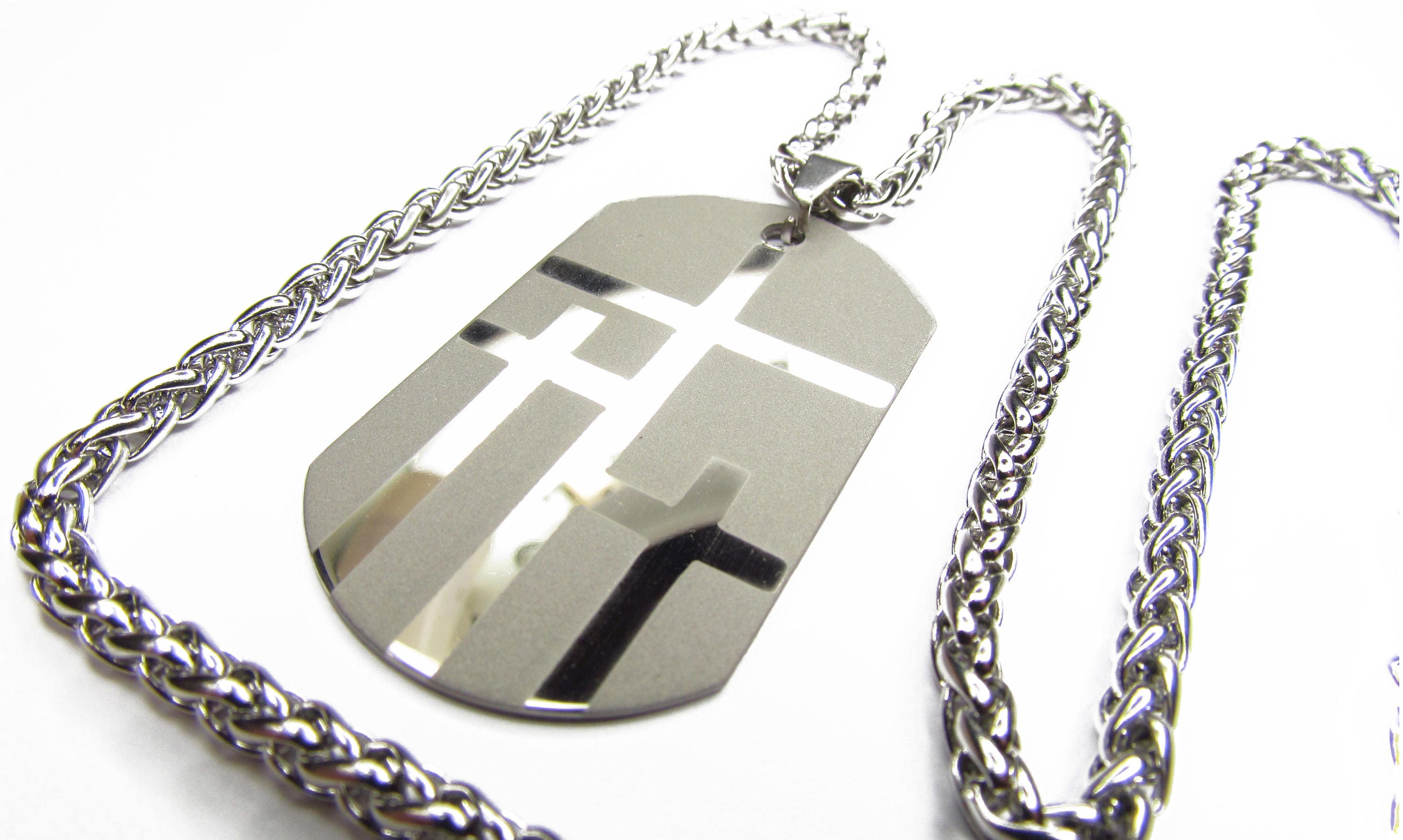 Dog tag necklace with large silver pendant featuring three cross shapes, silver chain