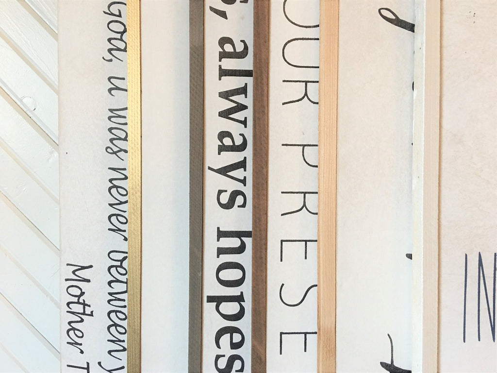 Wood framed wall sign close-up with partial scripture text in dark ink