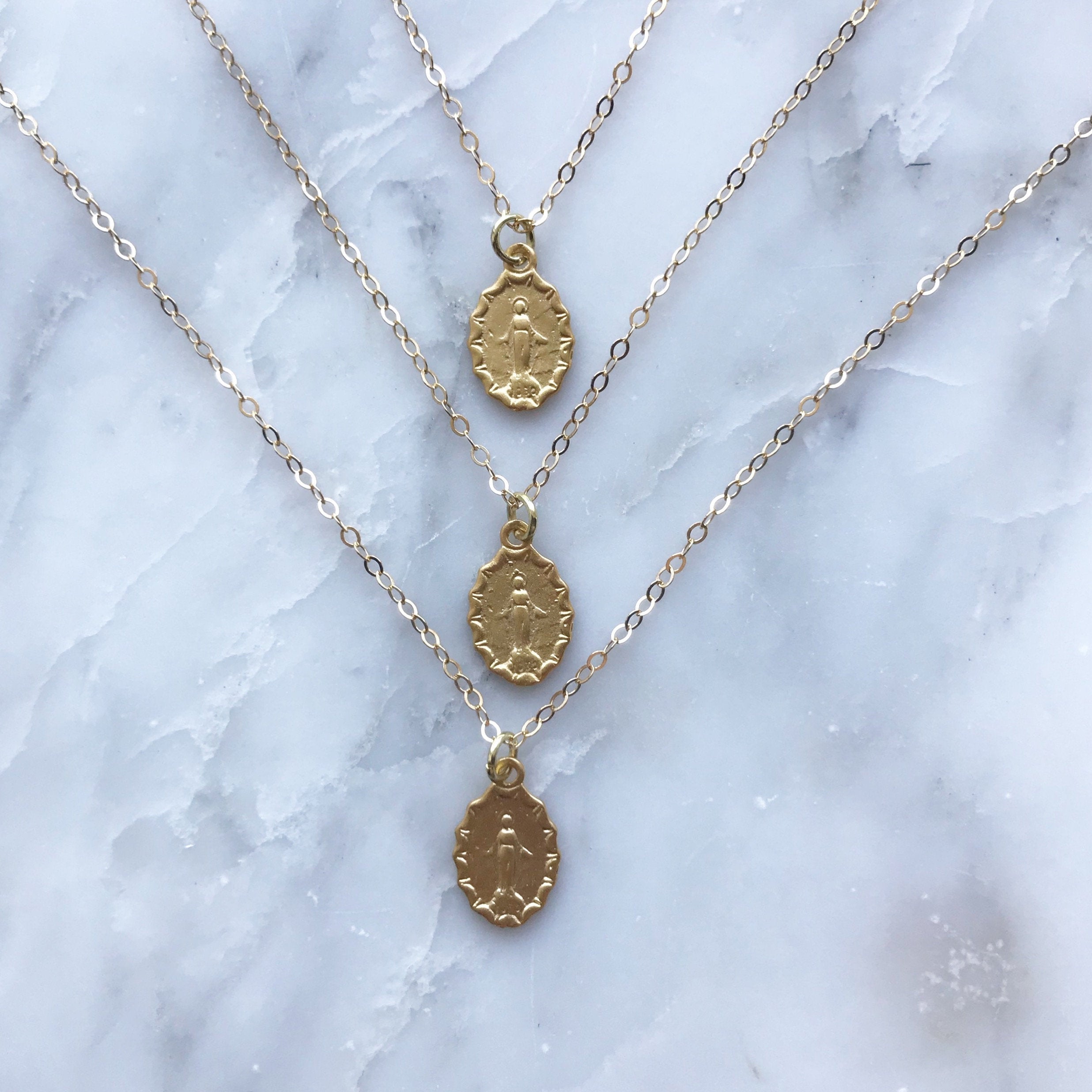 Medal pendant necklace with three oval medallion charms on fine chain