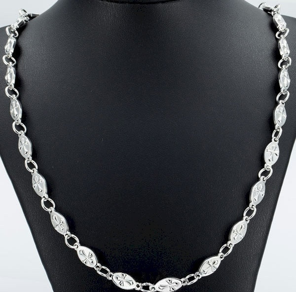 Silver chain necklace with oval cross links shown on display bust