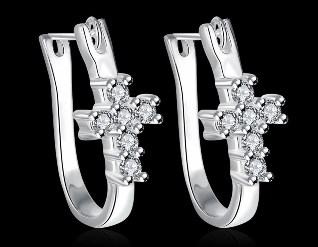 Silver-tone cross huggie hoop earrings with clear CZ cross clusters, pair view.