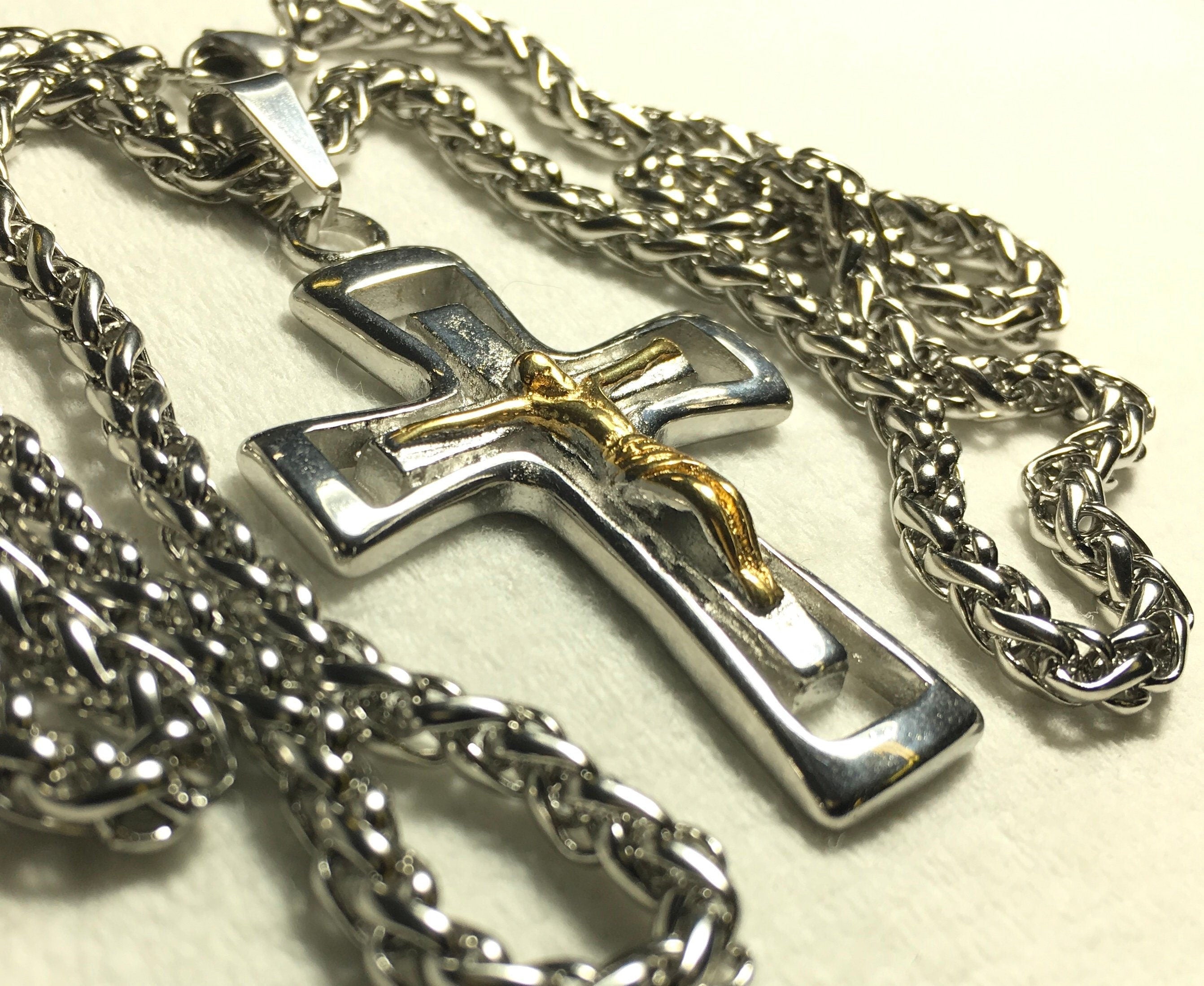 Silver and gold crucifix pendant necklace on twisted link chain