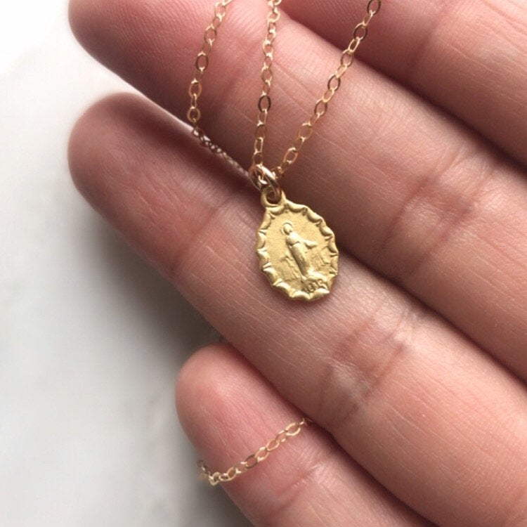 Medal pendant necklace with oval charm on a fine gold-tone chain