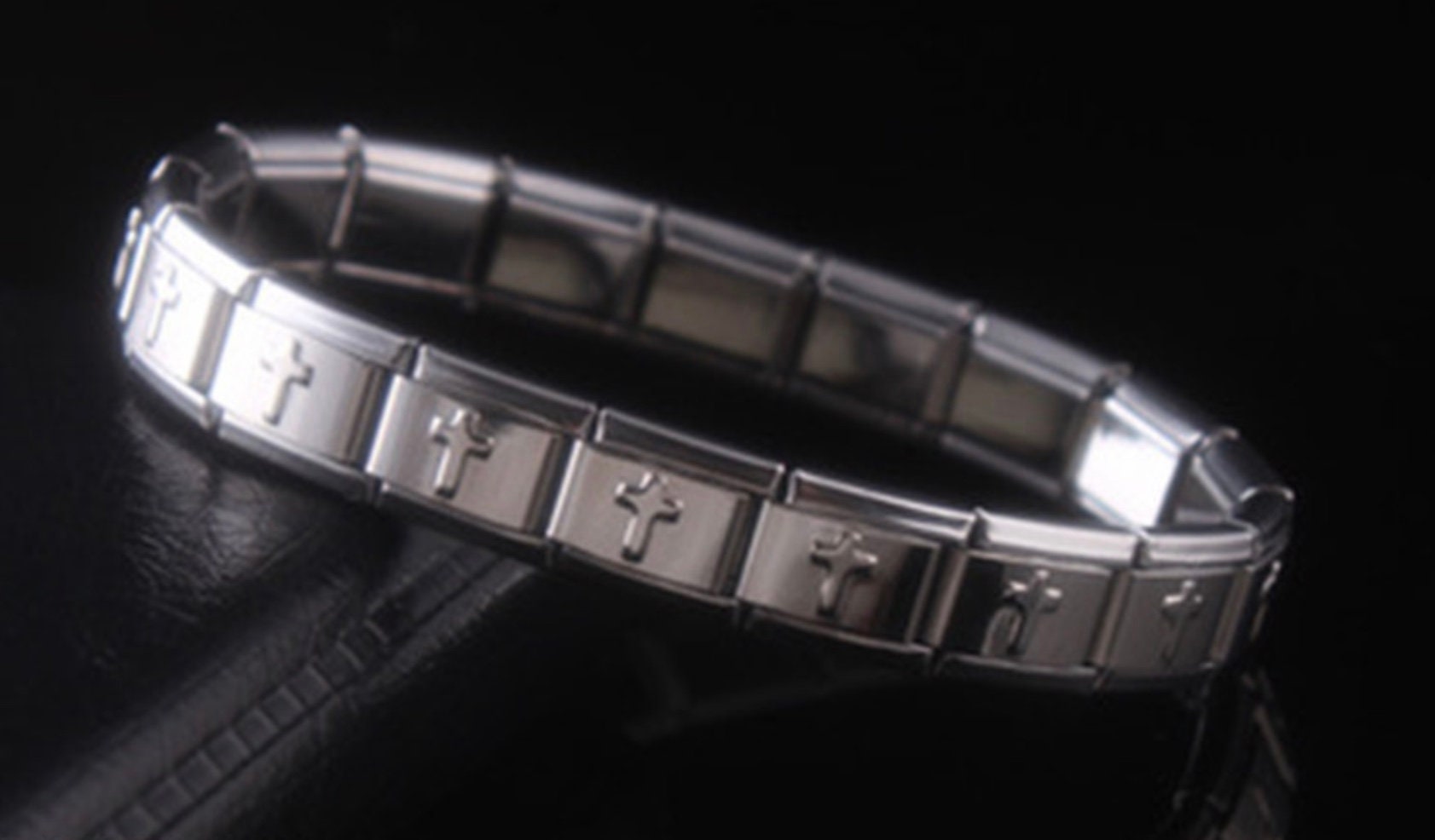 Silver stretch bracelet cuff with gold-tone cross link bars, side angle