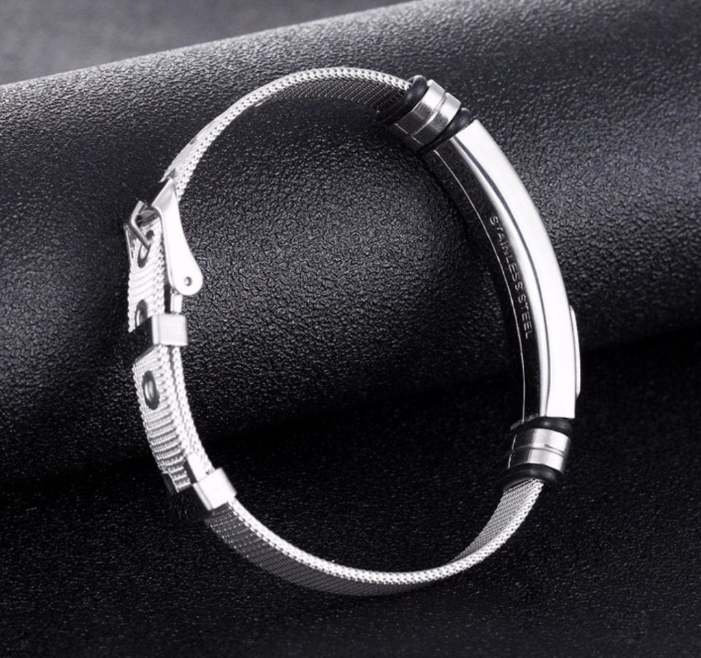 Silver mesh bracelet with black inlay accents and metal clasp on cuff frame
