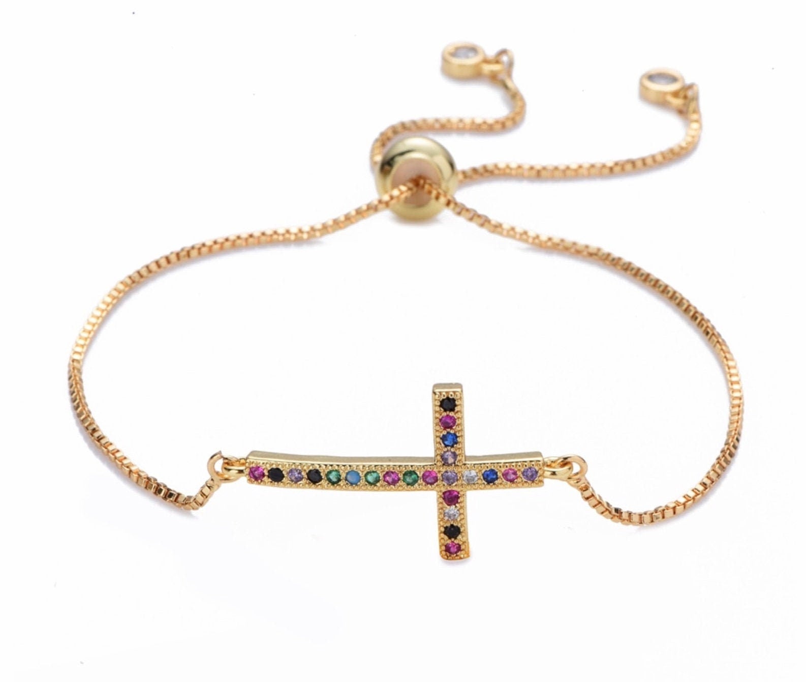 Gold-tone adjustable bracelet with colorful cz sideways cross pendant on chain