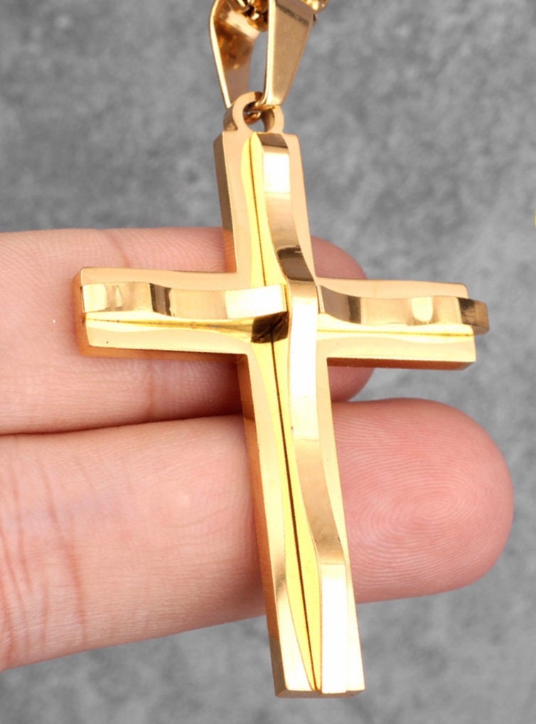Gold cross pendant on chain with glossy flat bar design