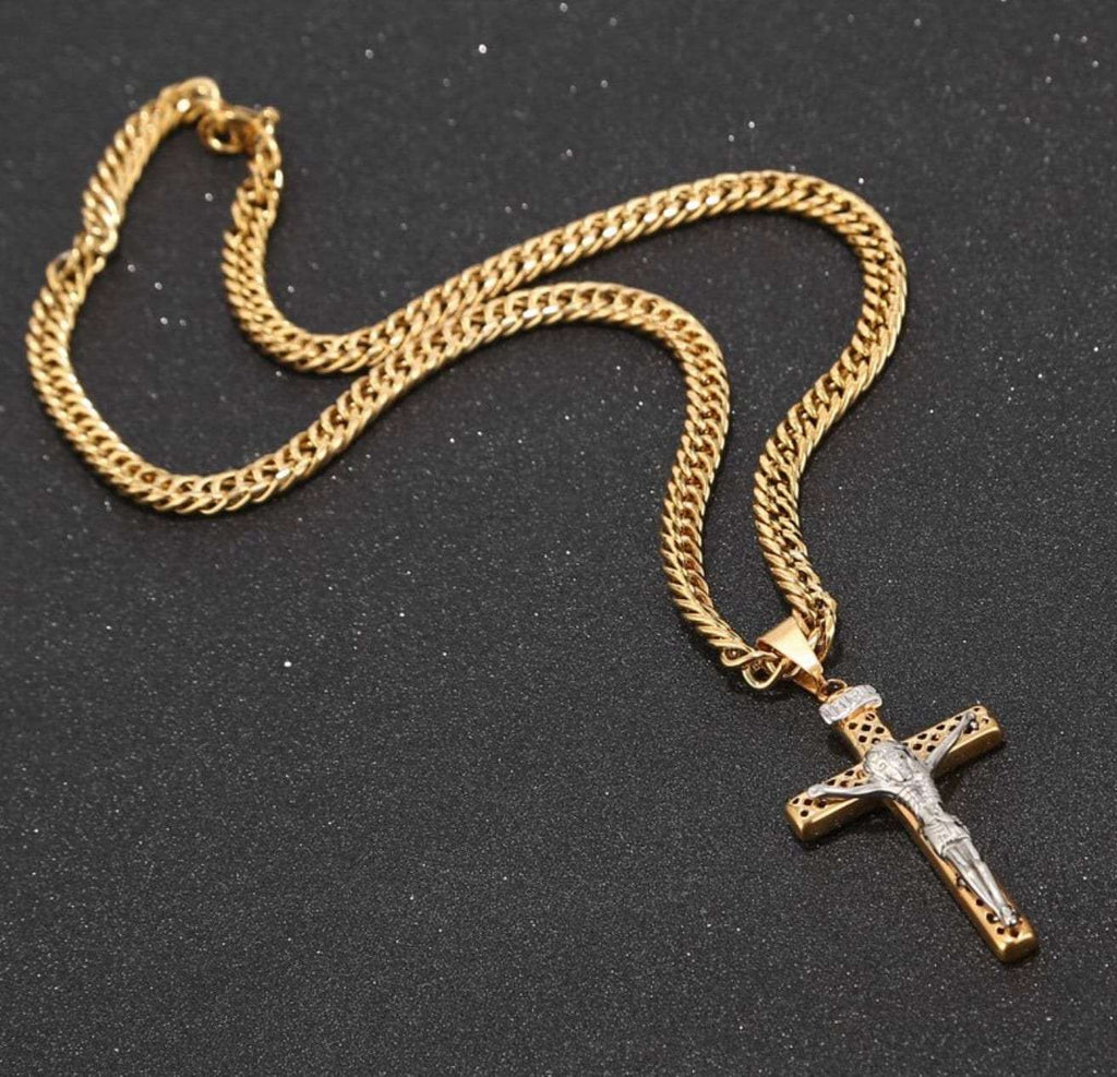 Gold-tone curb chain with crucifix cross pendant lying flat