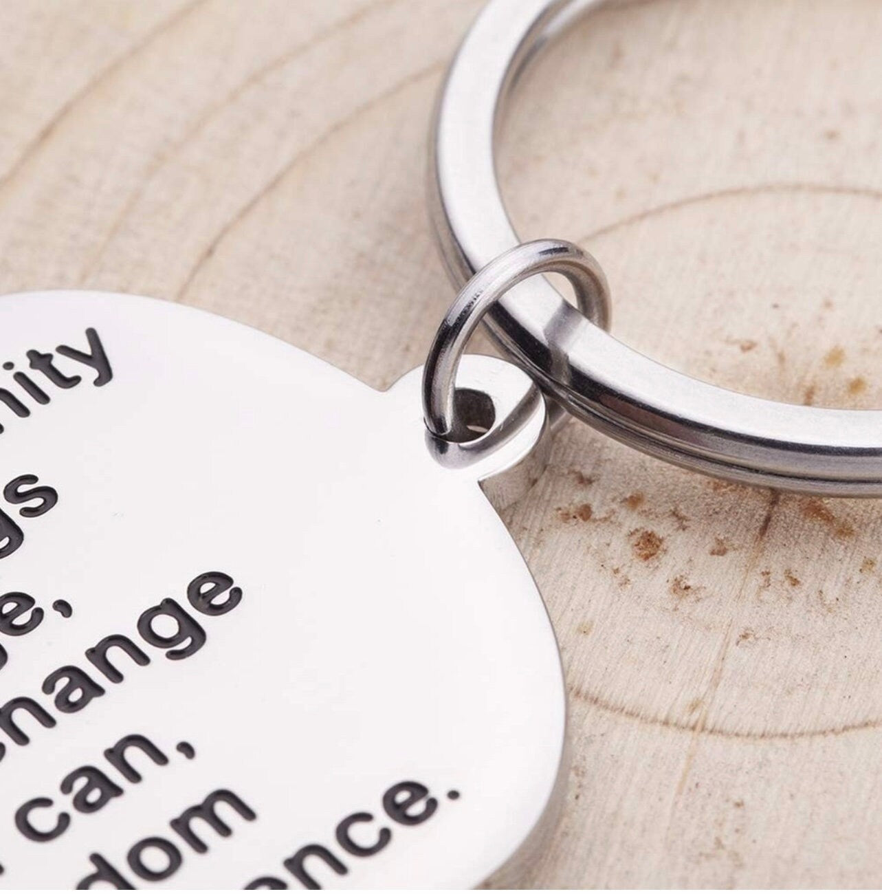 Silver dog tag keychain close-up with prayer text and metal key ring