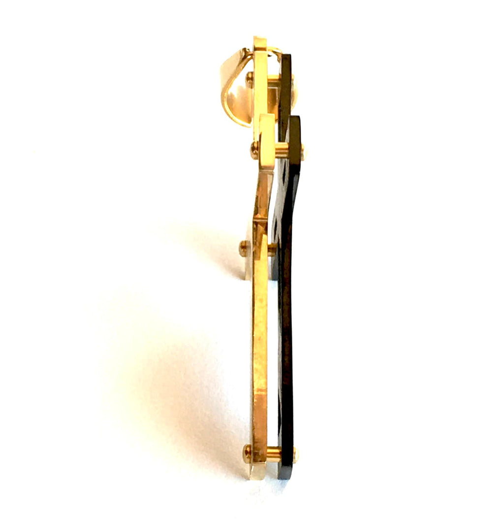 Gold and black crucifix cross pendant necklace, side view of thickness