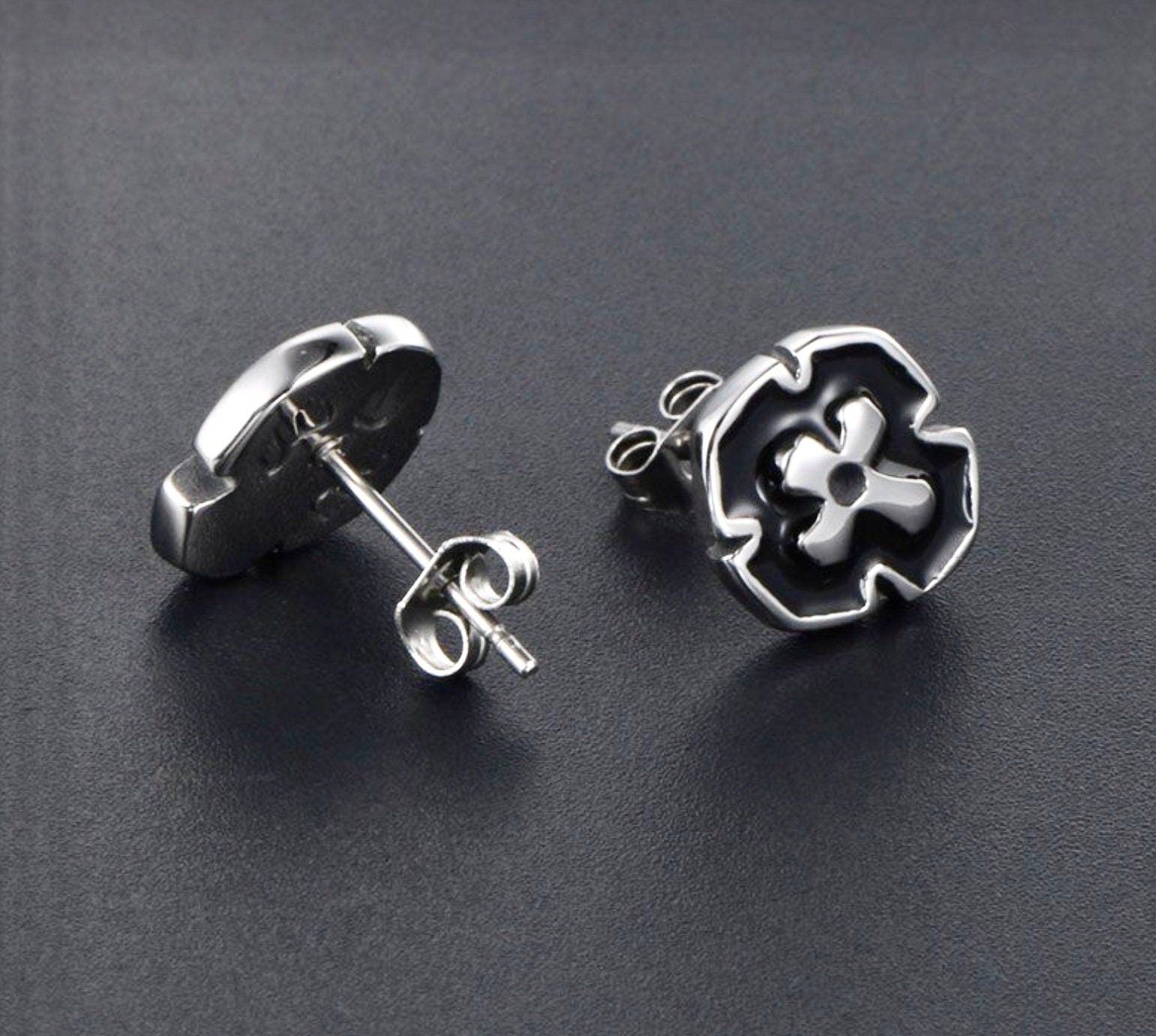 Cross stud earrings with black enamel faces, silver-tone circular frames and posts