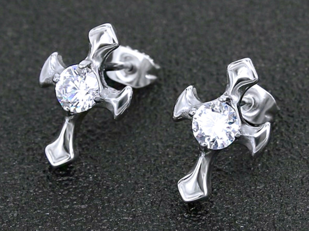 Silver zircon cross stud earrings on dark surface, front view with round center gems
