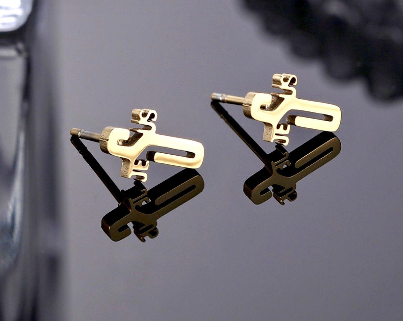 Gold cross-lettering stud earrings with push-back posts
