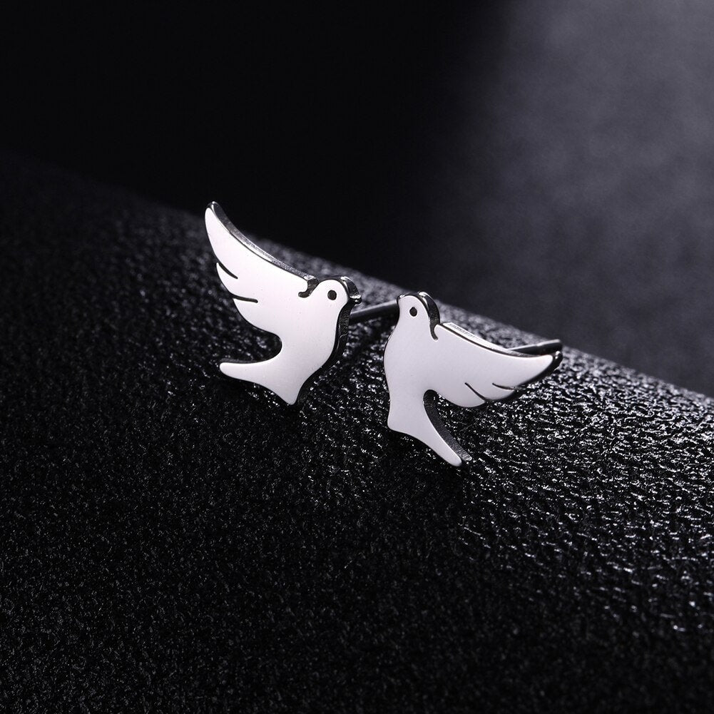 Silver dove stud earrings with curved wing silhouette