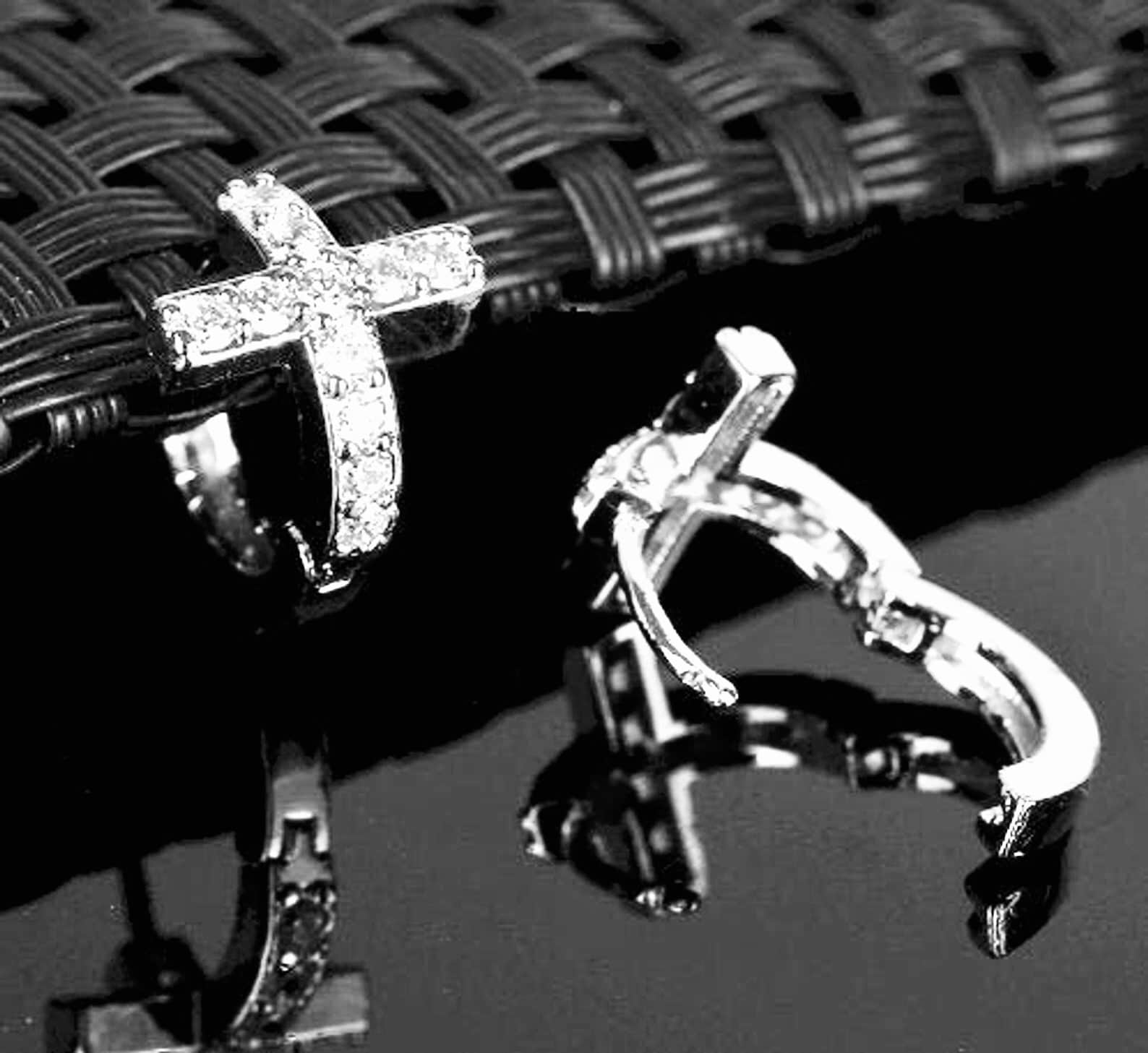 Cross hoop cuff earrings with silver cross charms and CZ-style stones, hinged metal cuffs