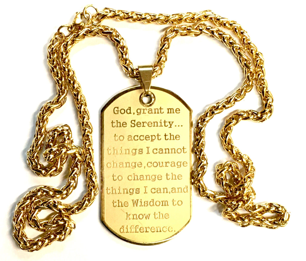 Gold dog tag necklace pendant on thick curb chain, Serenity Prayer text visible.