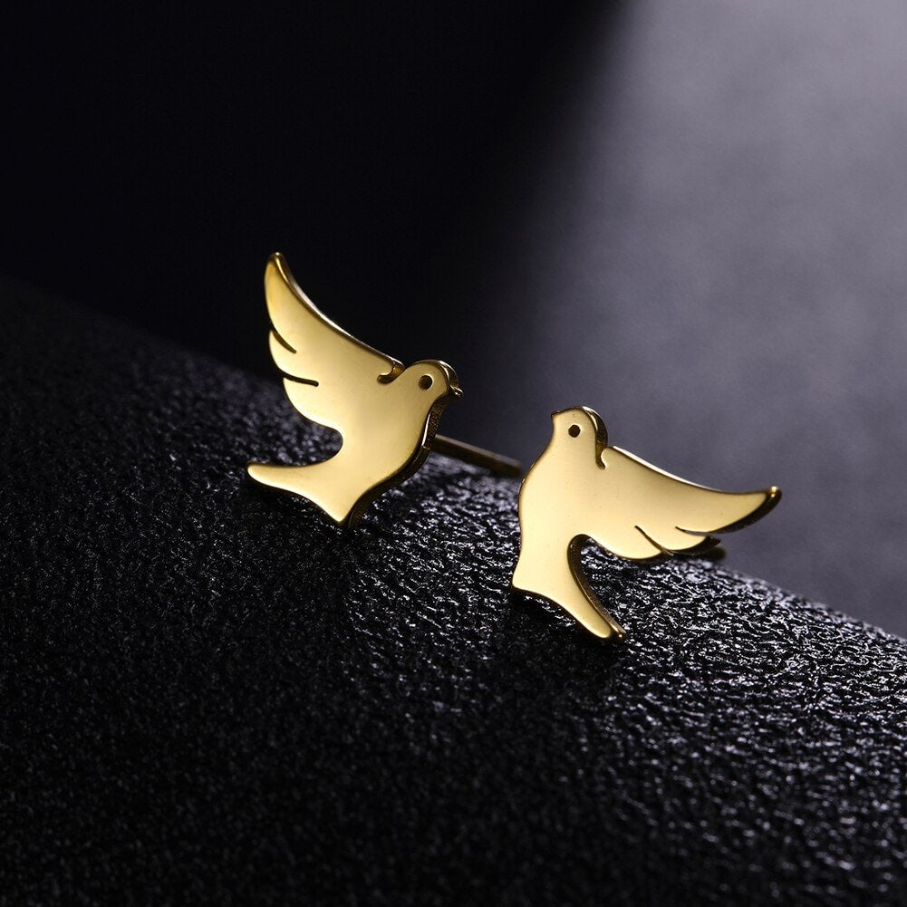 Gold dove stud earrings with curved wing silhouette