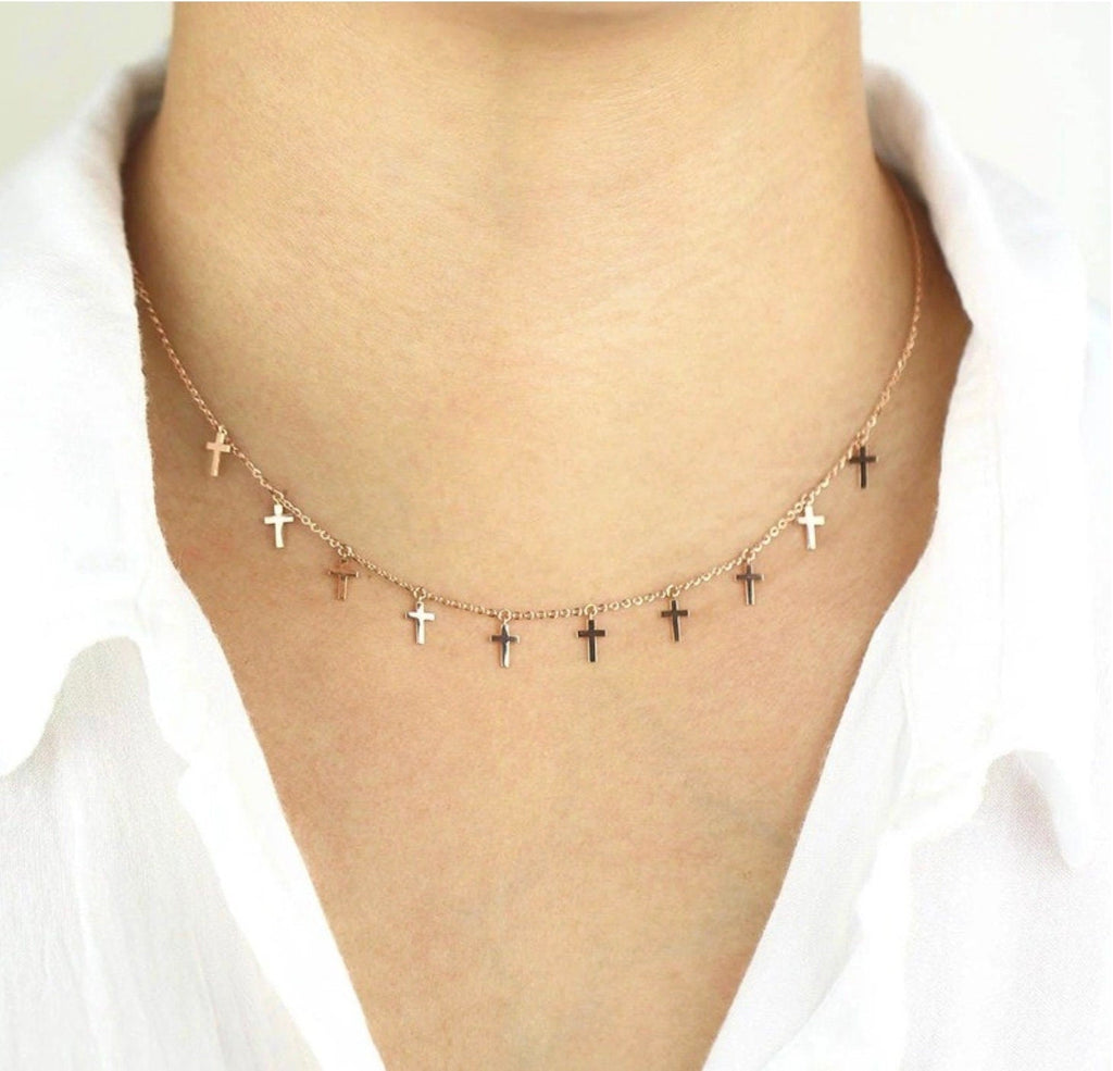 Silver cross chain choker necklace with small dangling crosses, shown on neck