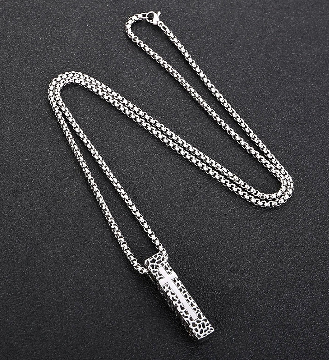 Crucifix shield necklace pendant with box chain links, shown from top angle
