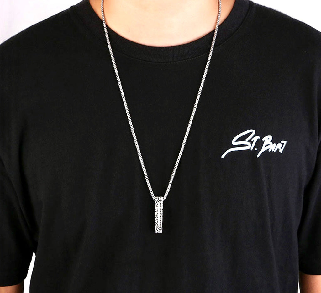 Crucifix pendant necklace on black shirt, silver tone box chain with rectangular cross