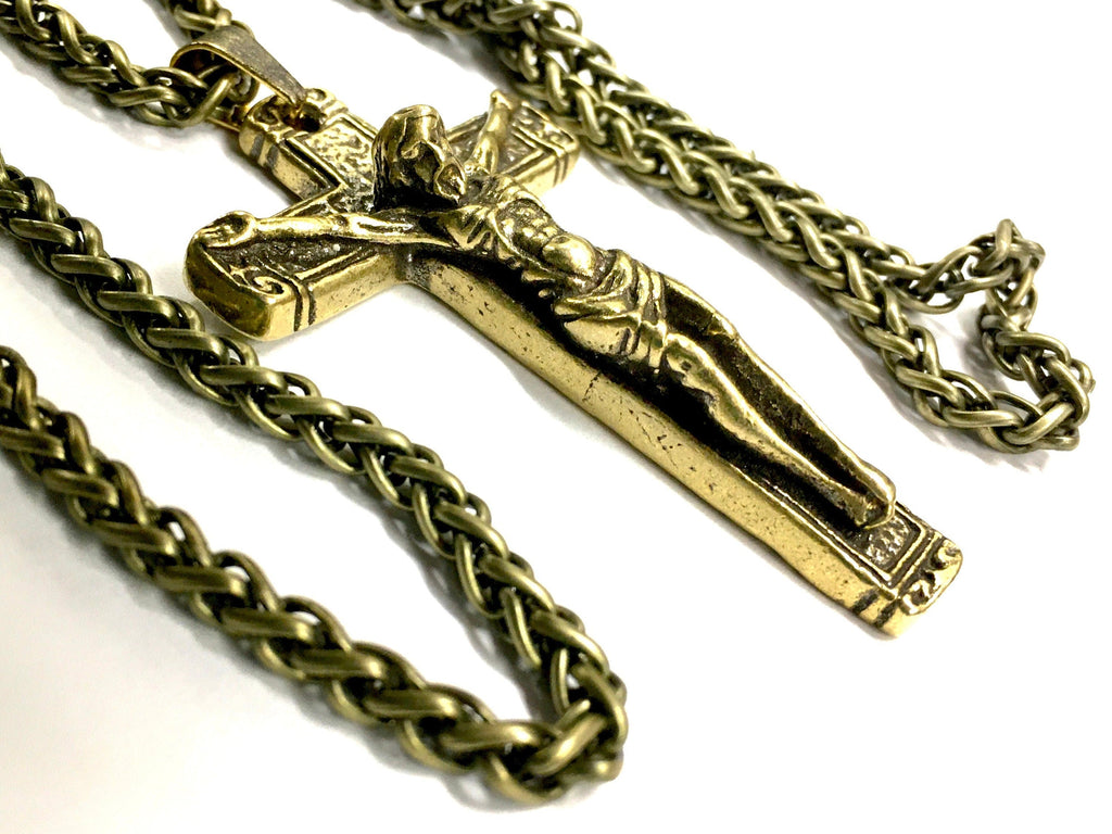 Bronze crucifix pendant on heavy link chain necklace, close-up.