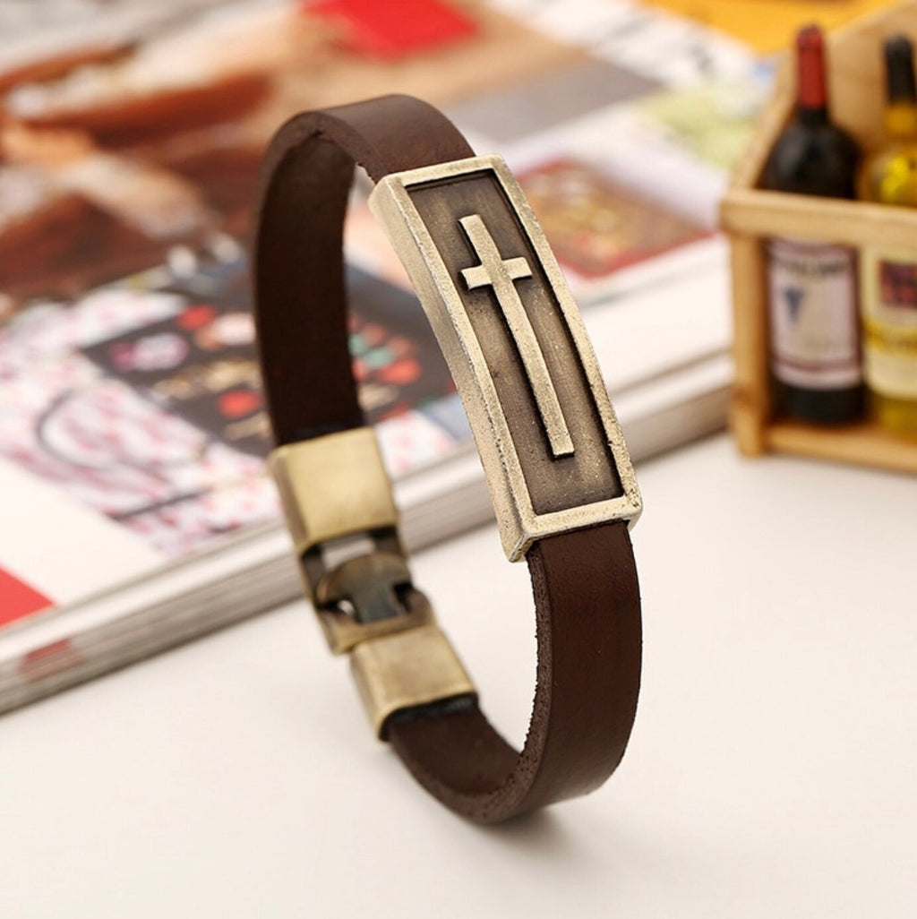 Brown leather cross bracelet with gold-tone rectangular frame and raised cross