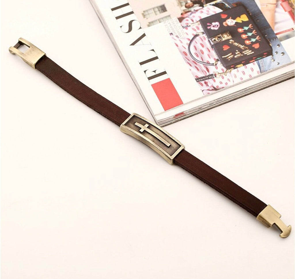 Brown leather cross bracelet with gold-tone square clasp and raised cross detail