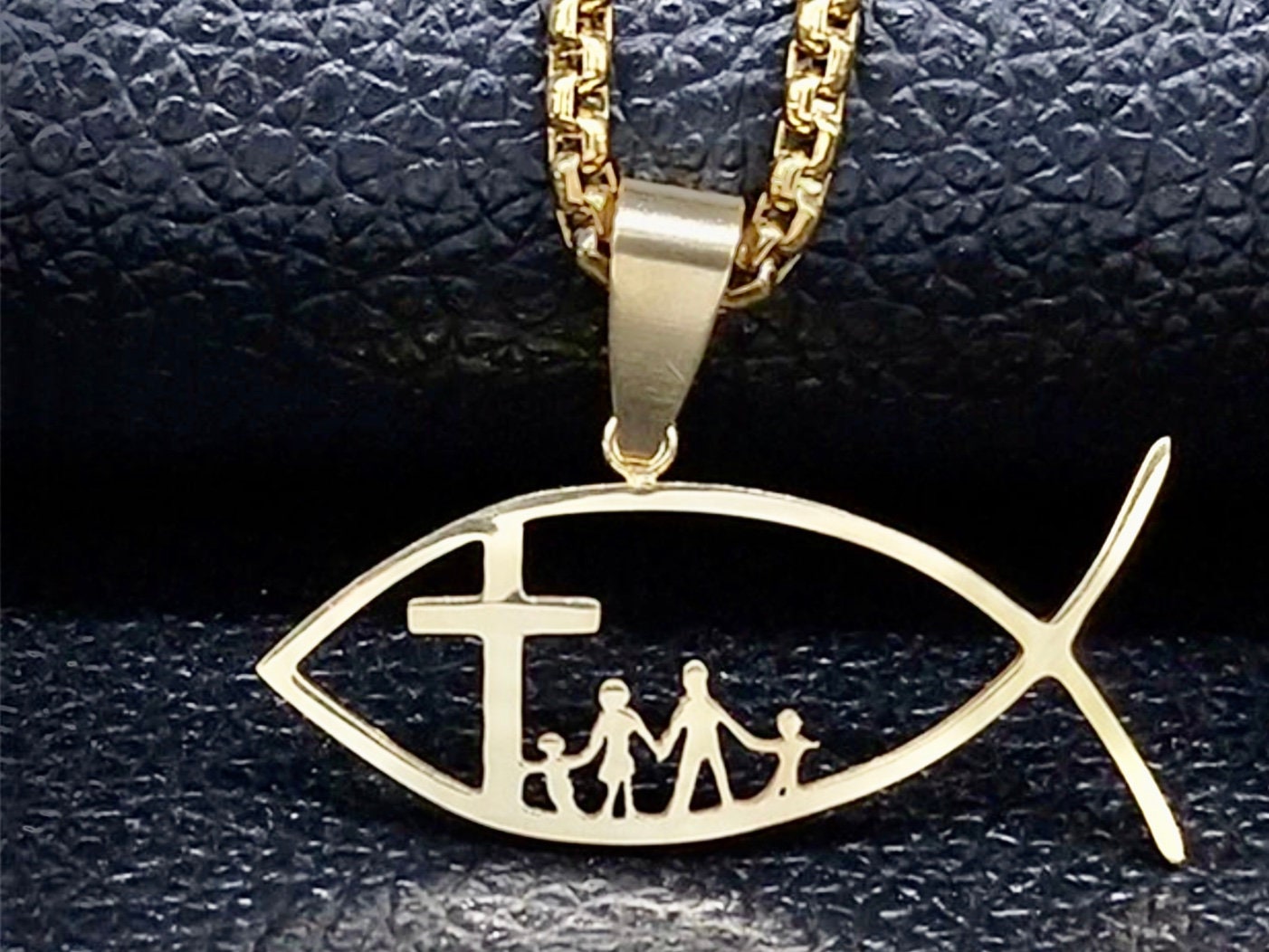 Silver-tone fish pendant necklace with cross and family figures