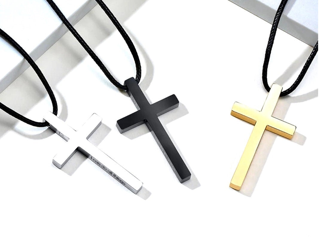 Men's cross necklaces on black cords, silver, black, and gold metal pendants