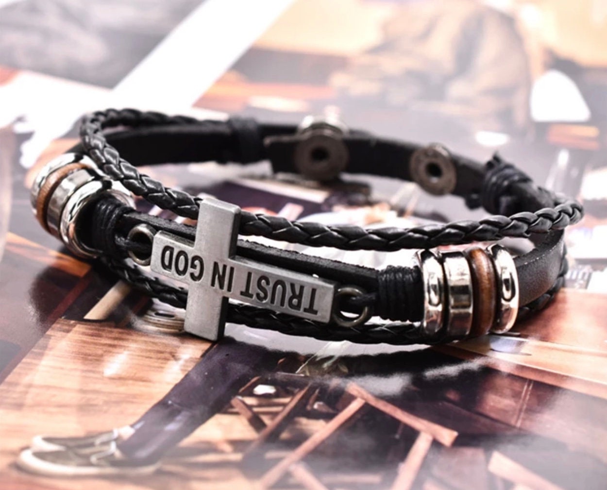 Black leather 3-wrap bracelet with cross-shaped clasp and engraved “TRUST IN GOD”