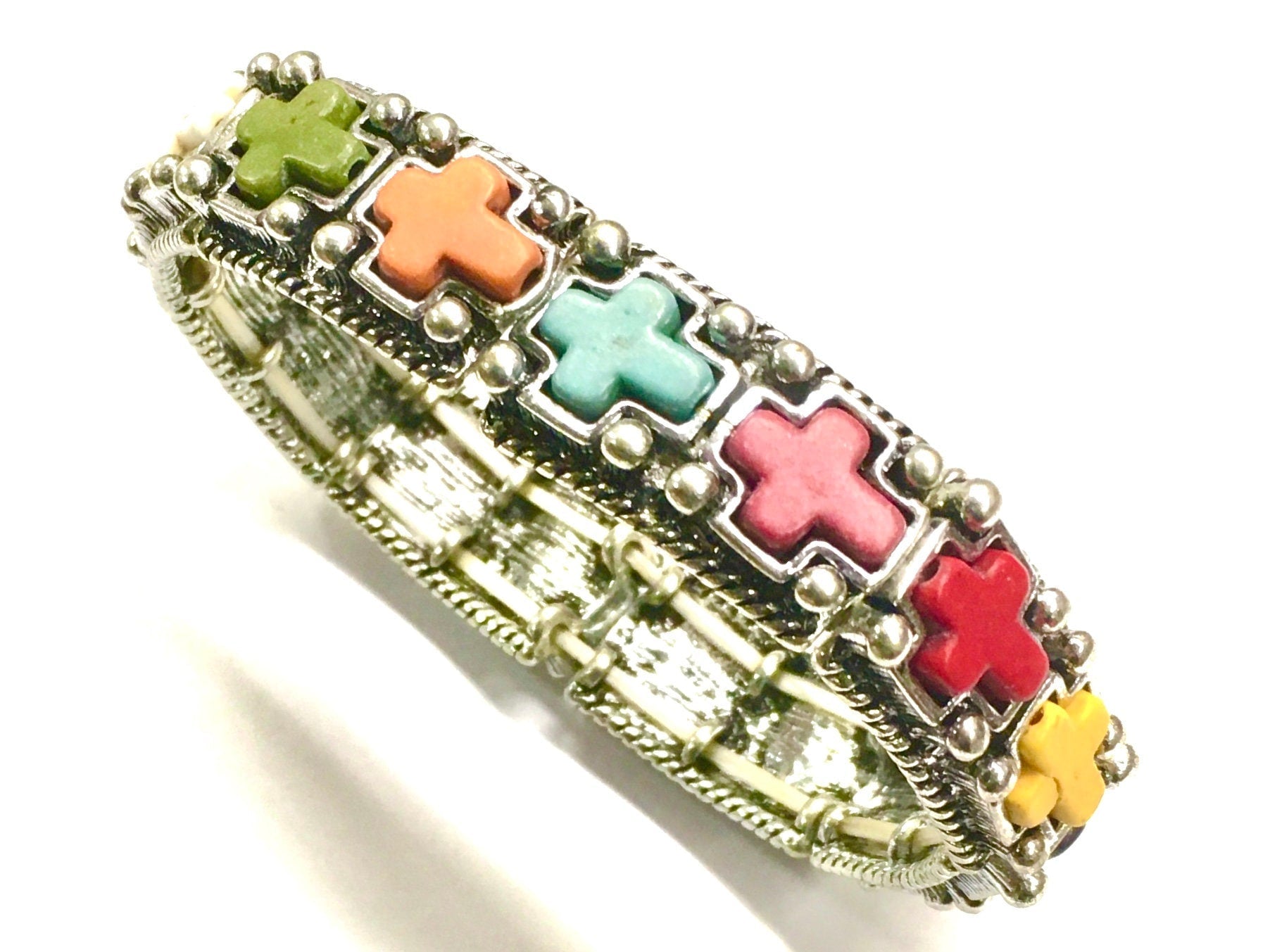 Silver cross stretch bracelet with green, orange, teal, pink, and red cross inlays
