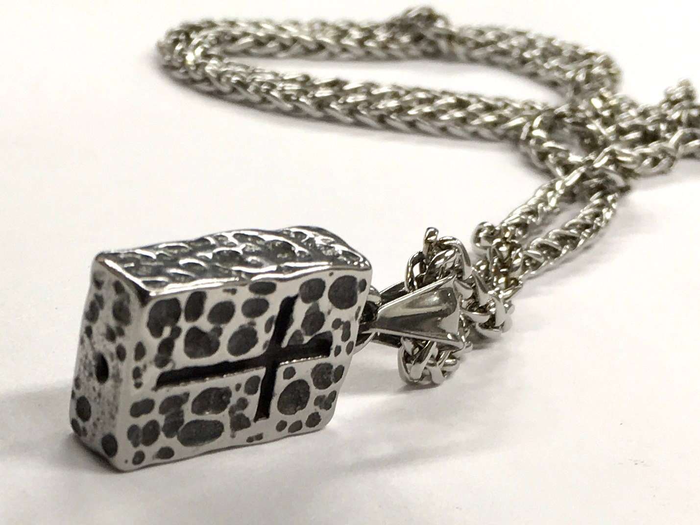 Hammered rectangle cross pendant on stainless link chain, side view